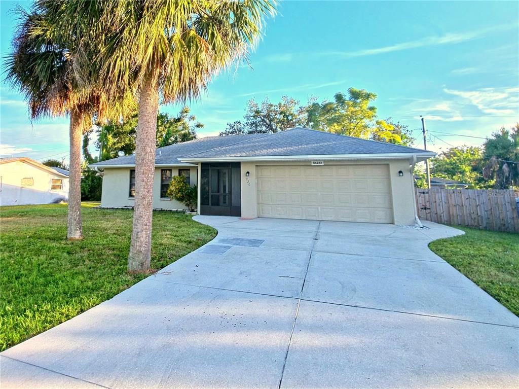 a front view of a house with a yard and a garage