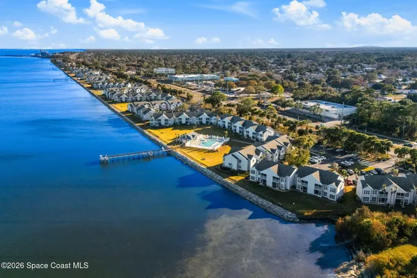 an aerial view of a house with a ocean view