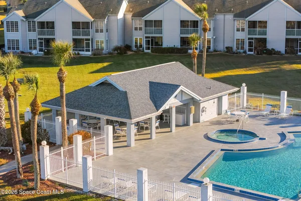 a view of a house with swimming pool and sitting area