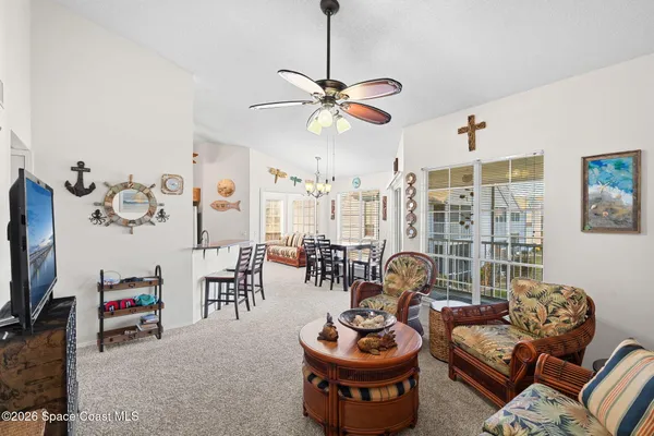 a living room with furniture a rug and a window