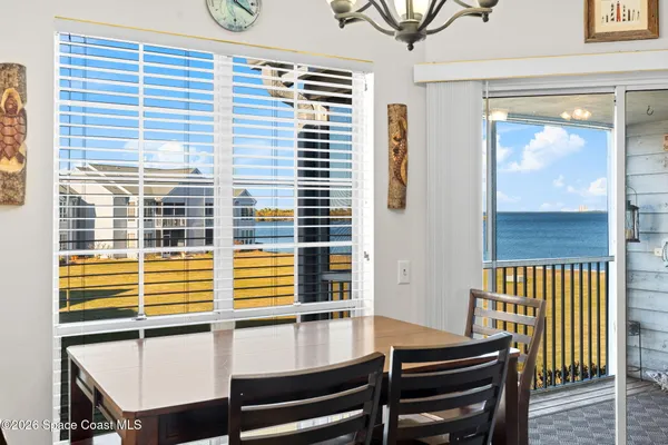 a view of a dining room with furniture and a window