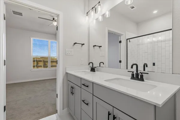 an empty room with a ceiling fan and carpet
