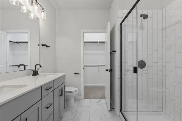 a bathroom with a sink double vanity and a mirror