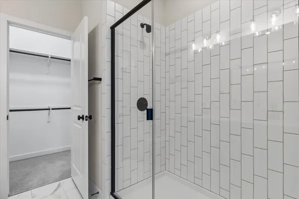 a bathroom with a double vanity sink a mirror and shower