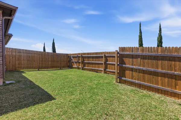 a view of house with backyard