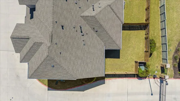 an aerial view of a house with a swimming pool