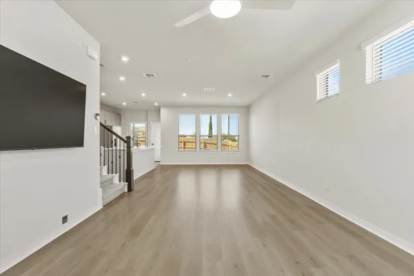a view of an empty room with wooden floor