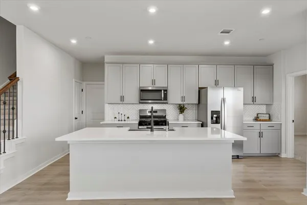 a view of a kitchen with wooden floor and a window