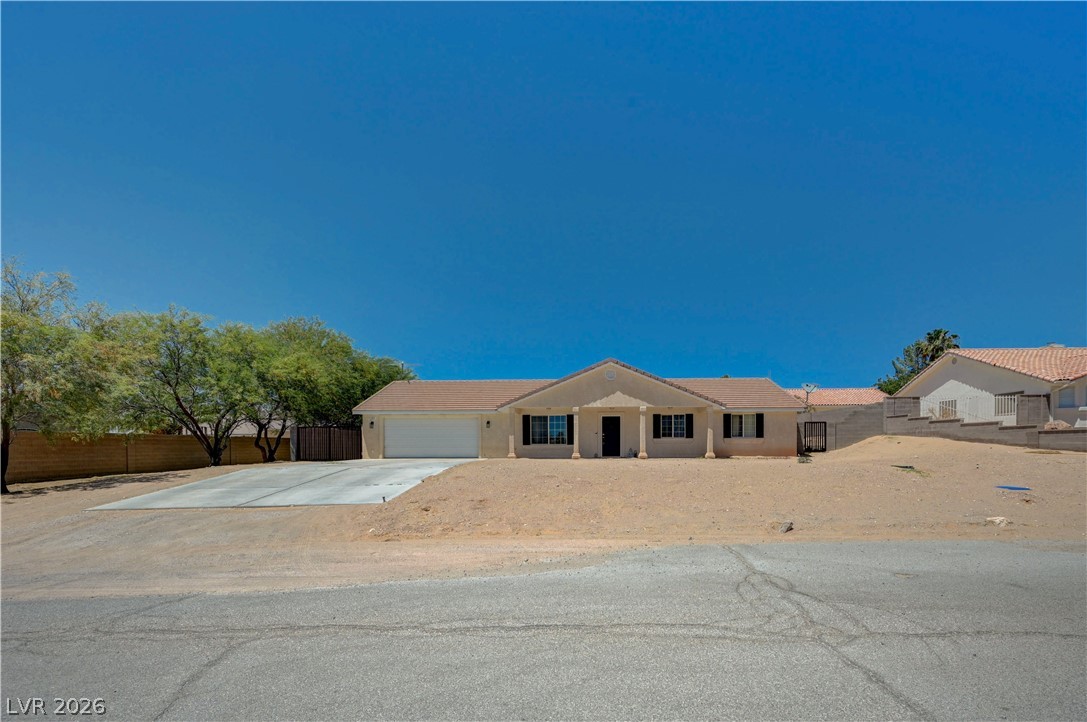 1272 Liston Avenue Logandale, NV 89021 - Photo 3 of 61 A classic facade with a deep-set porch welcomes you to this single-story residence.