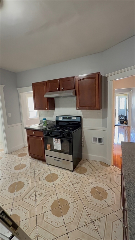 a kitchen with stainless steel appliances kitchen island granite countertop a sink and cabinets