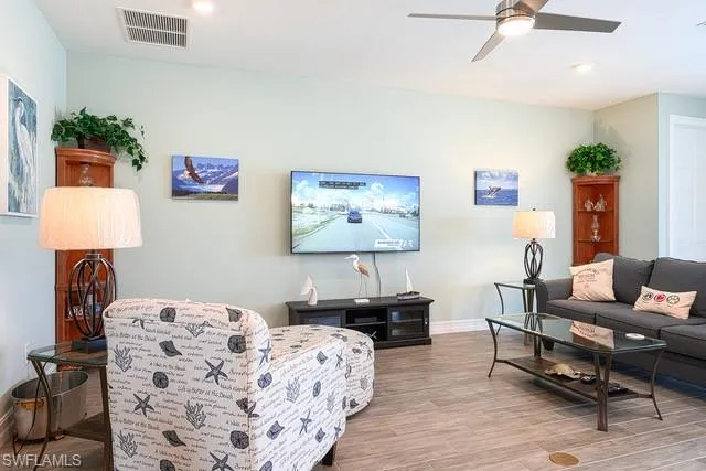 a living room with furniture and a lamp