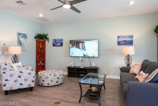 a bedroom with furniture and a wooden floor