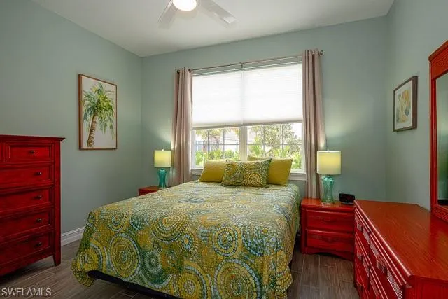 a bedroom with two beds and a lamp on the dresser