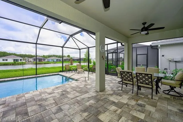 a view of a swimming pool with a garden and lake view