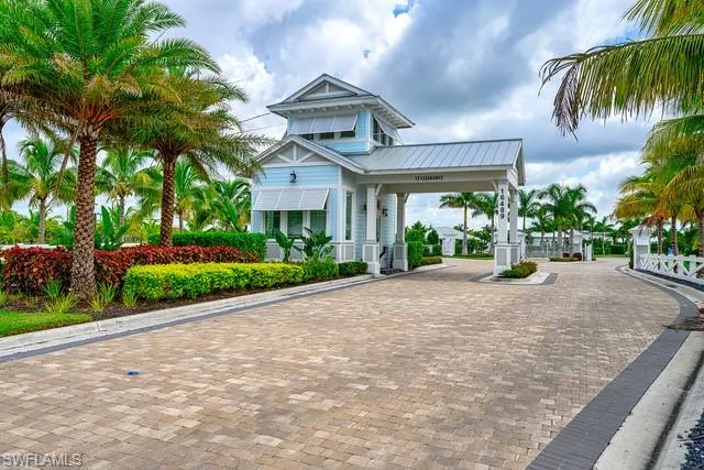 a view of a street with a building and palm trees