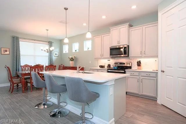 a kitchen with a sink cabinets and wooden floor