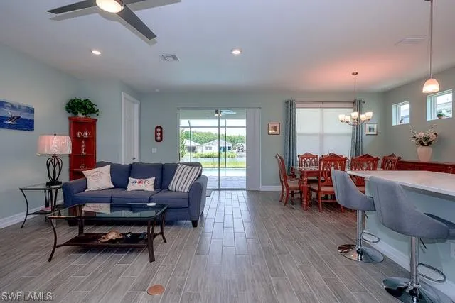 a living room with furniture and a wooden floor