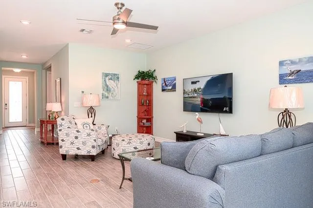 a living room with furniture and a flat screen tv