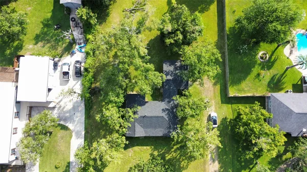 an aerial view of a house with a yard and garden