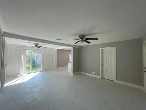 a view of a big room with closet and windows
