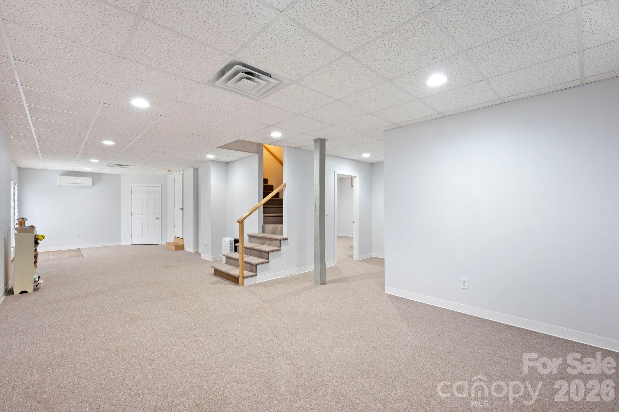 1606 High Ridge Drive Stanley, NC 28164 - Photo 32 of 43 an empty room with stairs and a view of living room