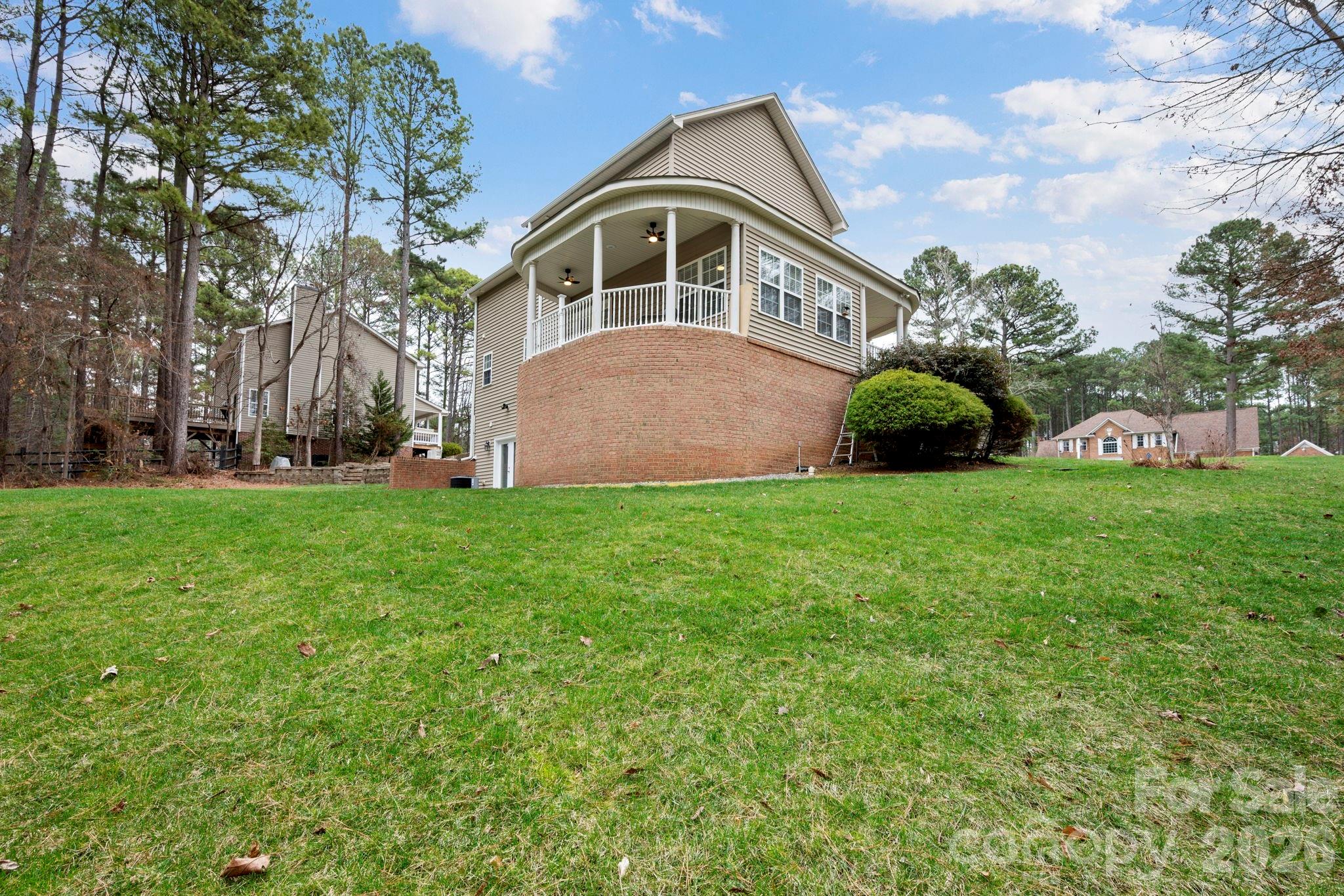 1606 High Ridge Drive Stanley, NC 28164 - Photo 42 of 43 a front view of a house with garden and trees