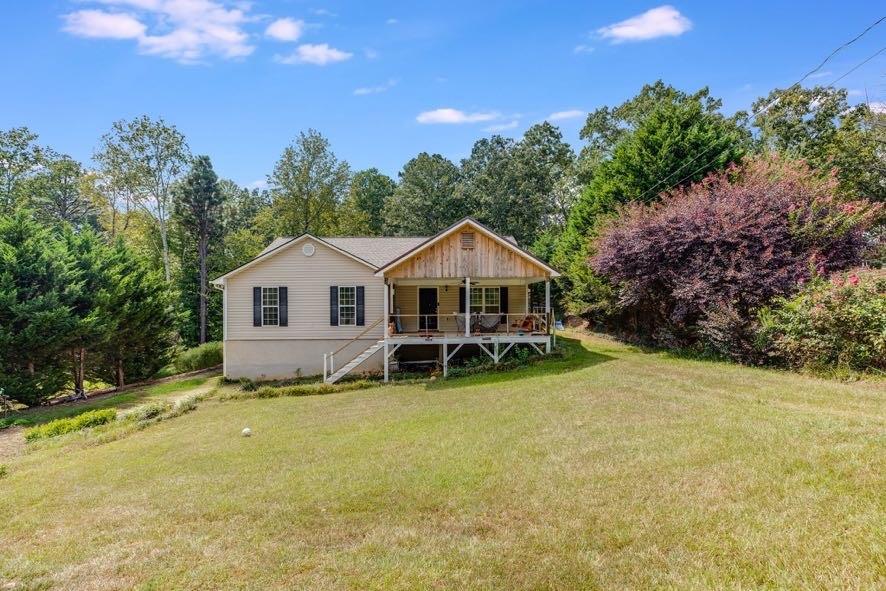 43 Mimosa Street Buchanan, GA 30113 - Photo 1 of 33 a front view of a house with yard and green space