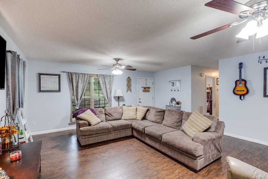 43 Mimosa Street Buchanan, GA 30113 - Photo 15 of 33 a living room with furniture and a chandelier
