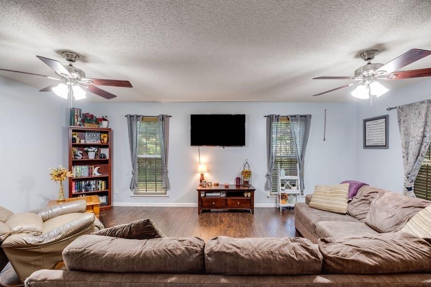 43 Mimosa Street Buchanan, GA 30113 - Photo 16 of 33 a living room with furniture ceiling fan and a flat screen tv