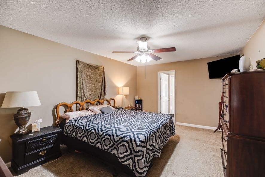 43 Mimosa Street Buchanan, GA 30113 - Photo 17 of 33 a bedroom with a bed and a chandelier