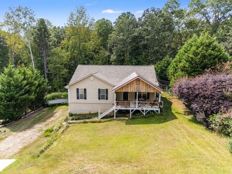 43 Mimosa Street Buchanan, GA 30113 - Photo 2 of 33 a view of a house with a big yard and large trees