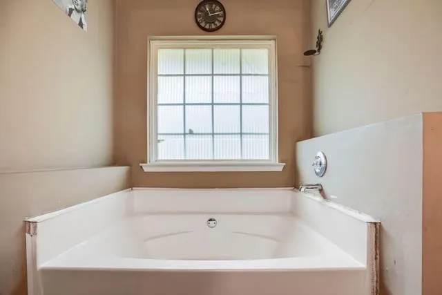 a bathroom with a granite countertop sink a bathtub and a shower