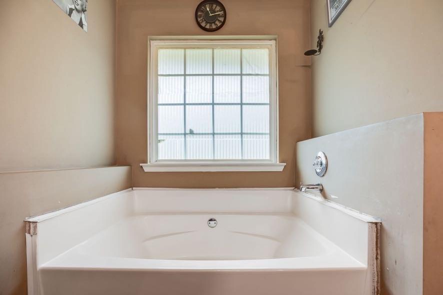43 Mimosa Street Buchanan, GA 30113 - Photo 24 of 33 a white bath tub sitting next to a window