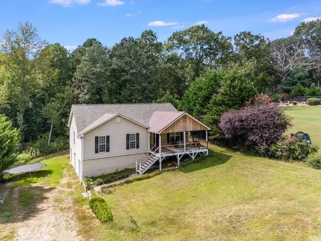 a front view of a house with a yard table and chairs