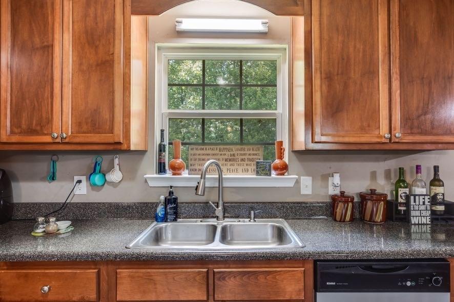 43 Mimosa Street Buchanan, GA 30113 - Photo 9 of 33 a kitchen with granite countertop stainless steel appliances a sink window and cabinets