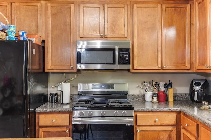43 Mimosa Street Buchanan, GA 30113 - Photo 10 of 33 a kitchen with stainless steel appliances granite countertop a stove microwave and refrigerator