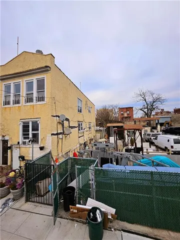 a view of a cars park next to a yard