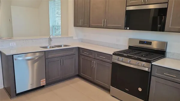 a kitchen with sink and cabinets