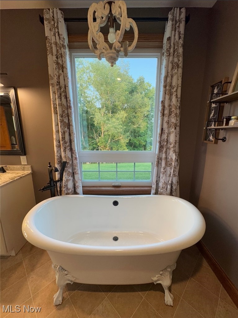 49402 Patton Road Jerusalem, OH 43747 - Photo 25 of 28 Full bath with vanity, tile patterned flooring, and a soaking tub
