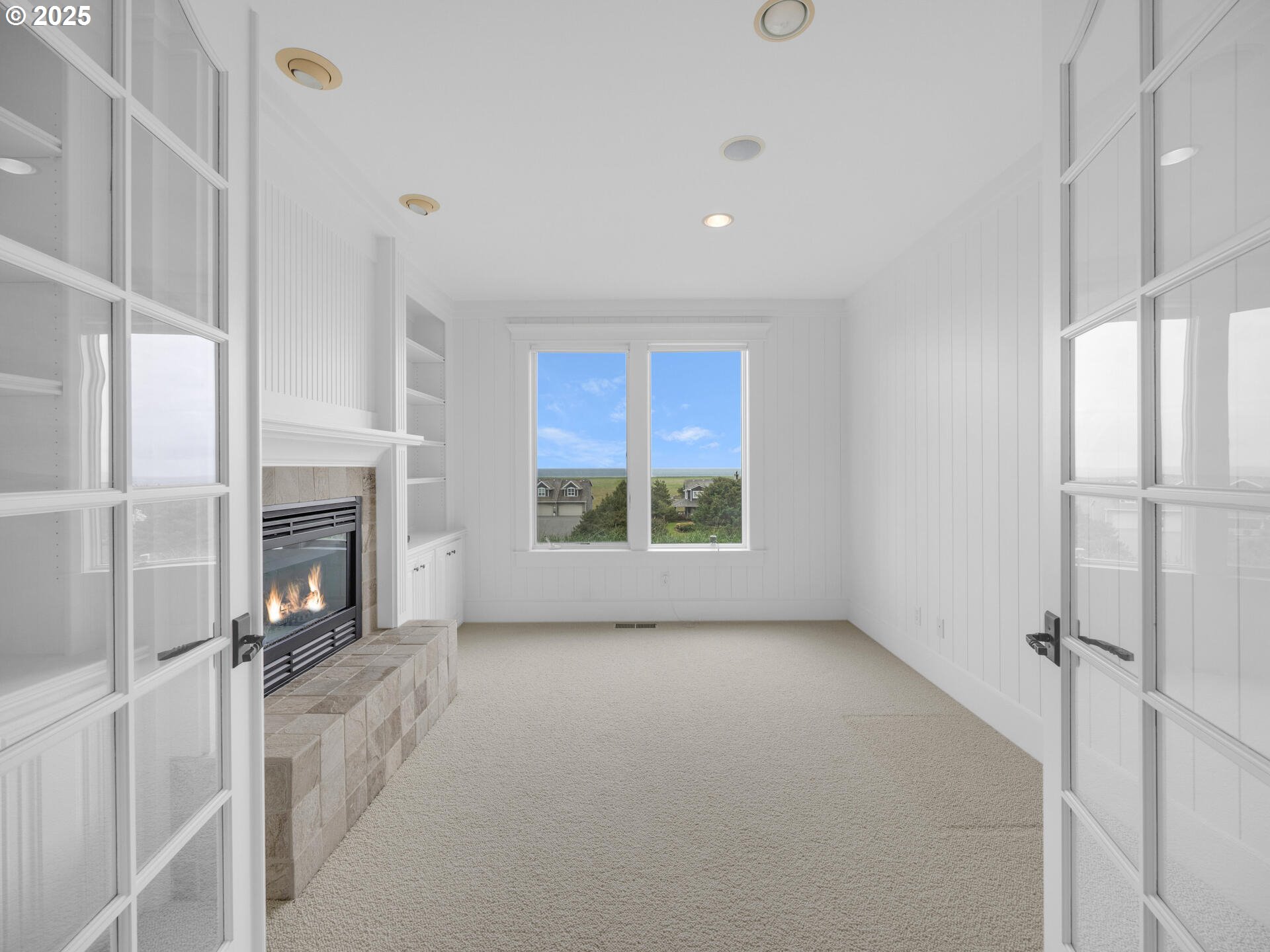 88902 Pinehurst Road Gearhart, OR 97138 - Photo 25 of 48 a view of an empty room with a fireplace and a window