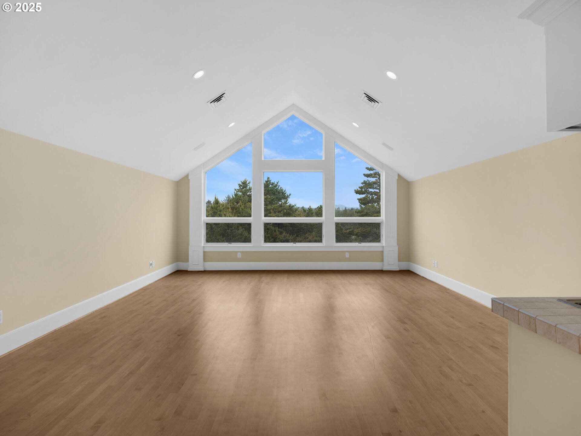 88902 Pinehurst Road Gearhart, OR 97138 - Photo 27 of 48 a view of an empty room with a window and wooden floor