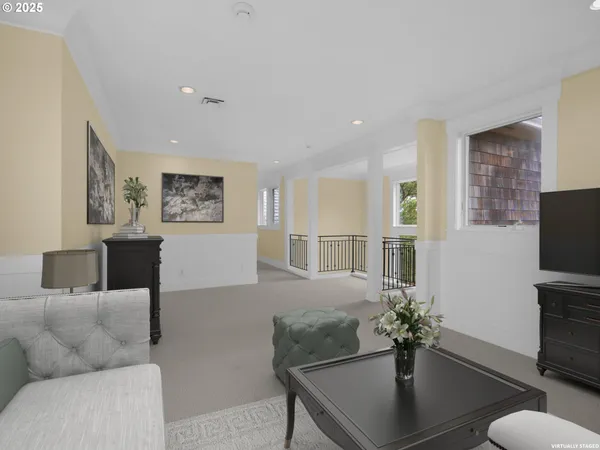 a living room with furniture potted plant and a flat screen tv
