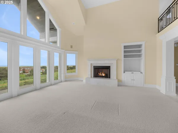 a view of an empty room with a fireplace and a window