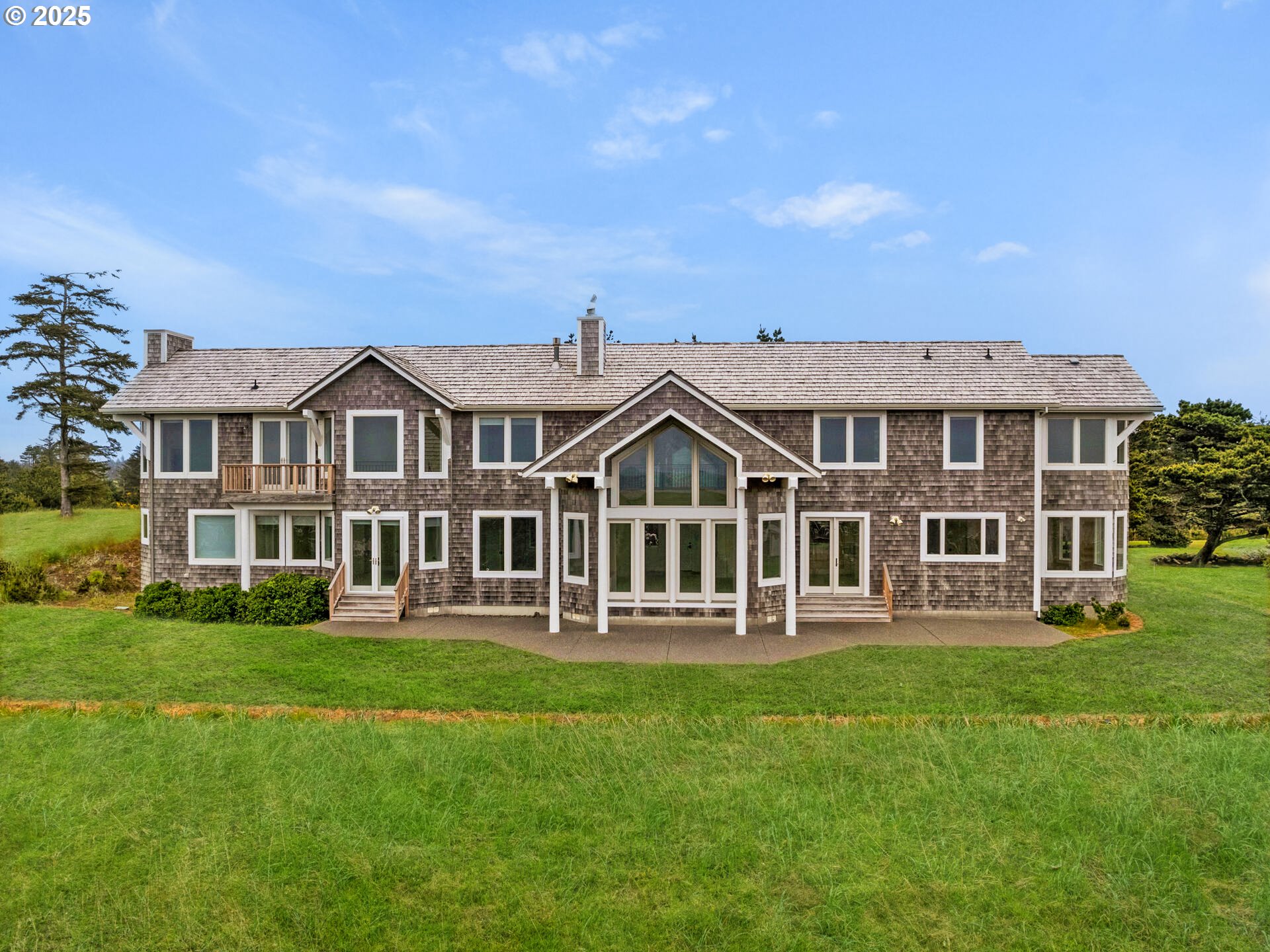 88902 Pinehurst Road Gearhart, OR 97138 - Photo 43 of 48 a front view of a house with a garden and trees