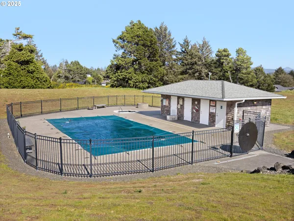 a view of a house with a swimming pool and sitting area
