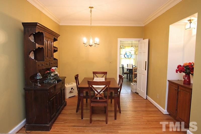 8314 Wycombe Lane Raleigh, NC 27615 - Photo 5 of 13 Dining Room with built-in cabinet and hardwood flooring.