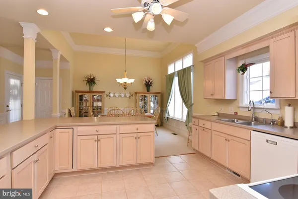 a large kitchen with a sink and cabinets