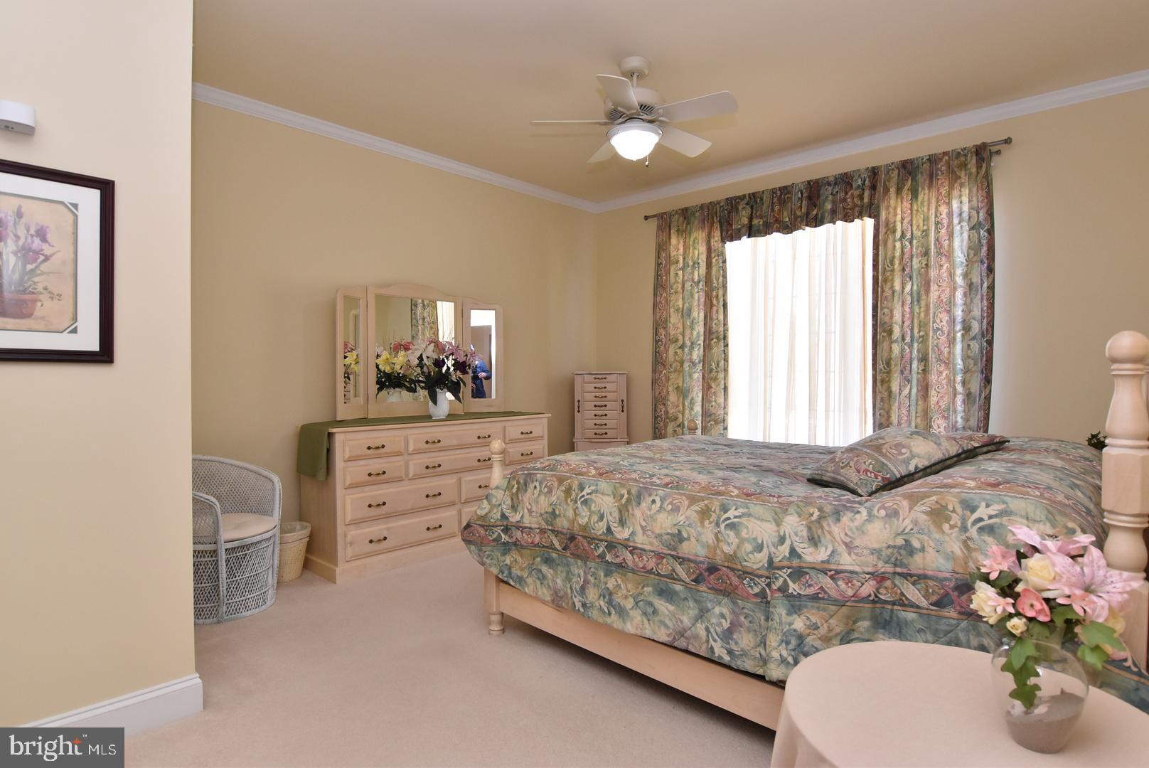 204 Turtle Cove, Unit 115 Laurel, DE 19956 - Photo 13 of 47 a bedroom with a bed and a dresser