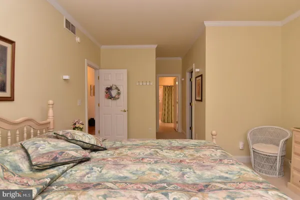a bedroom with a bed and a mirror