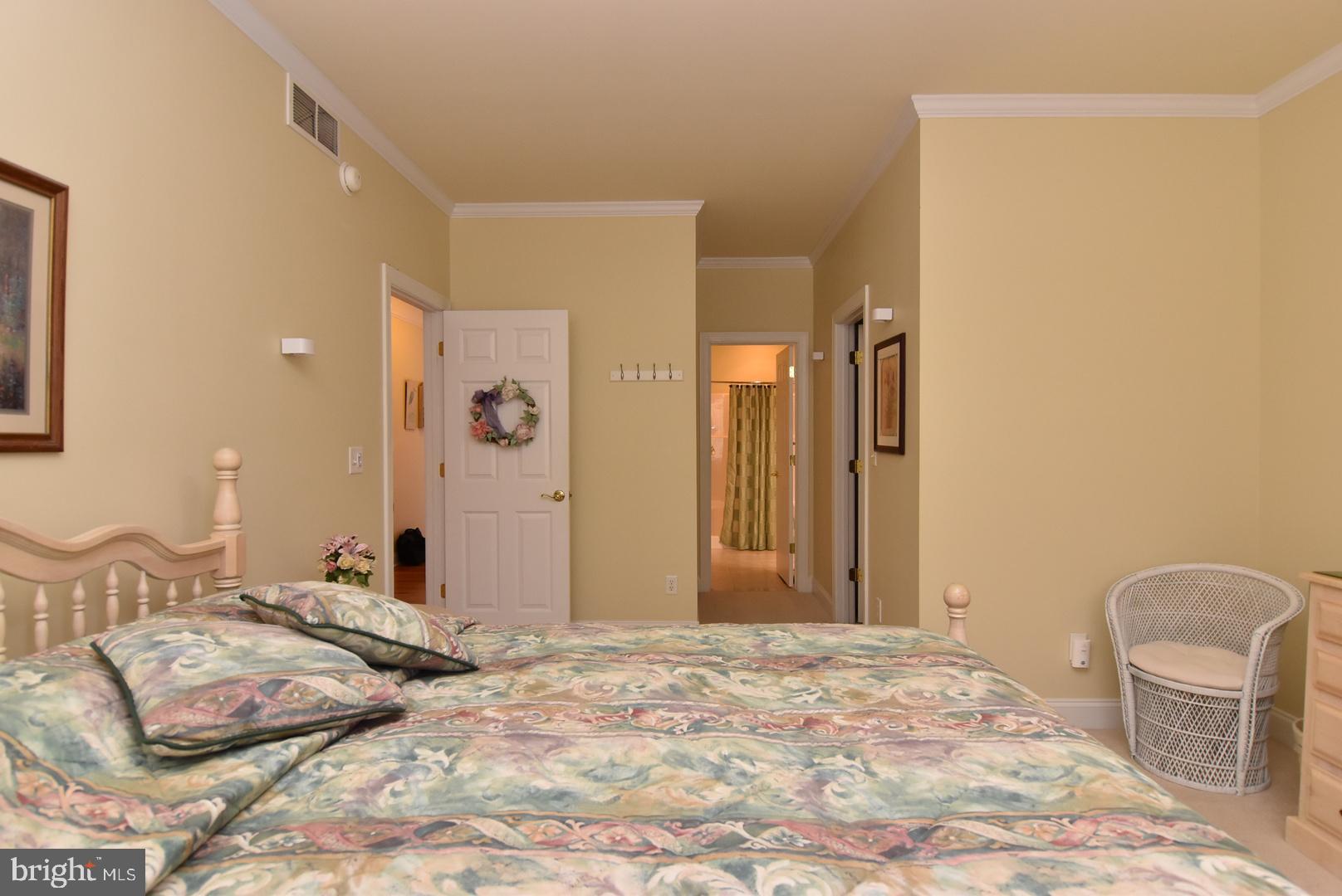 204 Turtle Cove, Unit 115 Laurel, DE 19956 - Photo 14 of 47 a bedroom with a bed and a mirror